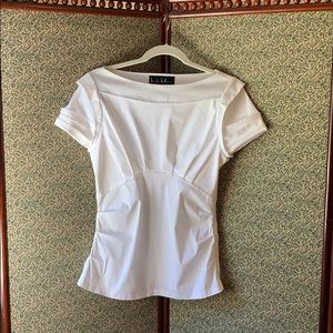 White cotton-spandex top with cap sleves.